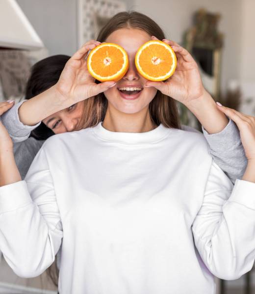 young-women-playing-with-oranges
